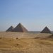 three pyramids in the desert with a sky background