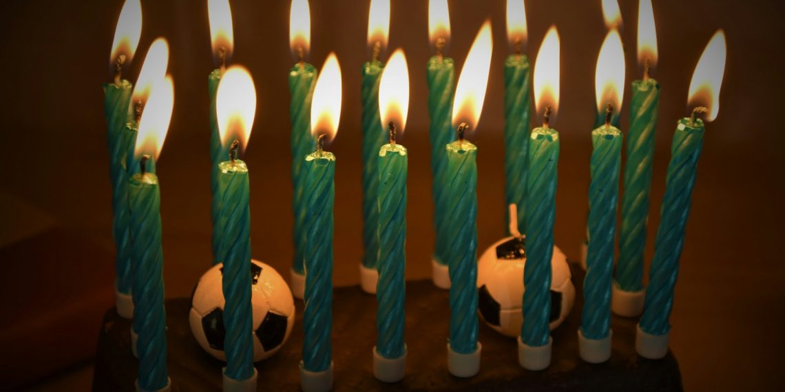 white candles on black surface