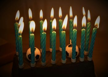 white candles on black surface