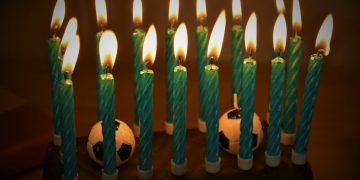 white candles on black surface