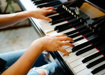 hands playing a piano