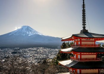 a pagoda with a mountain in the background