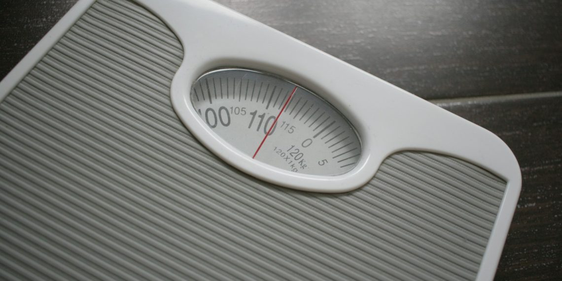 a bathroom scale sitting on top of a wooden table