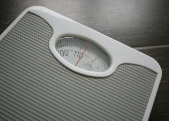 a bathroom scale sitting on top of a wooden table