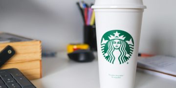 white starbucks disposable cup on white table