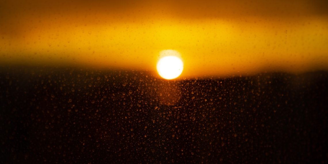 a sunset over a mountain