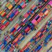 Aerial view of vibrant shipping containers at a busy Jakarta port, showcasing global trade.