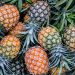 orange and green pineapple fruits